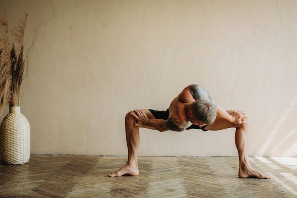 Man stretching in a sunrise light showing flexibility and calm